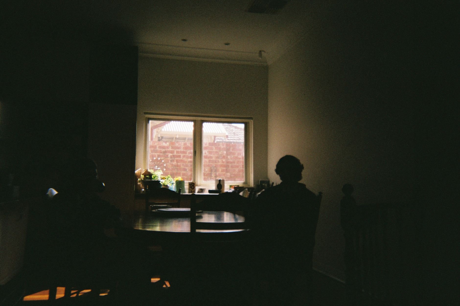 People gathered together in warm, soft natural light — a moment of quiet community.